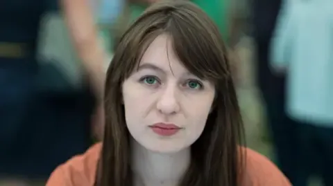 Sally Rooney claims she will not travel to the UK because of potential arrest